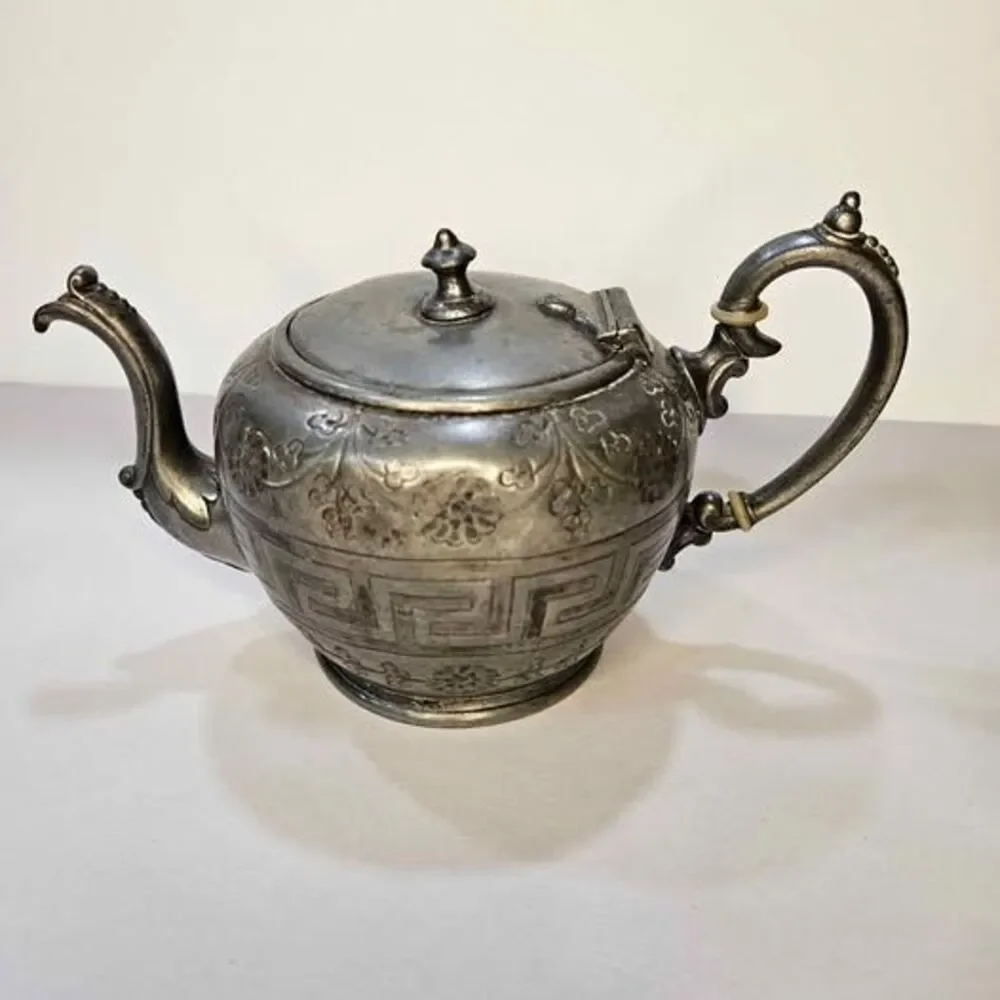 Antique silver-plated teapot Greek key pattern & embossed floral motifs.